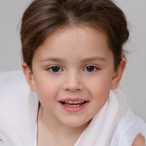 Joyful white child female with short  brown hair and brown eyes