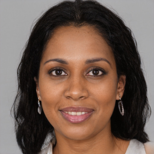 Joyful black young-adult female with medium  brown hair and brown eyes