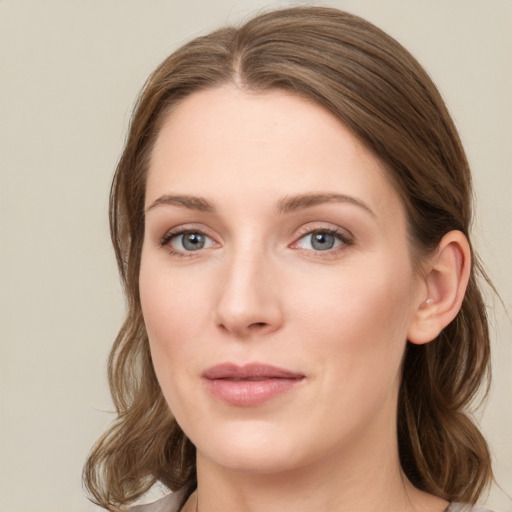 Joyful white young-adult female with medium  brown hair and green eyes