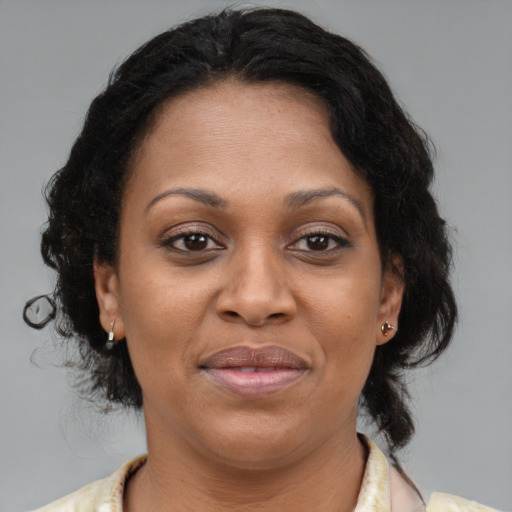 Joyful black adult female with medium  brown hair and brown eyes