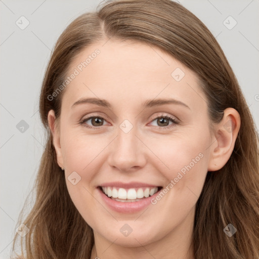 Joyful white young-adult female with long  brown hair and blue eyes