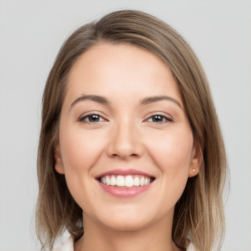 Joyful white young-adult female with medium  brown hair and grey eyes