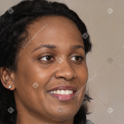 Joyful black young-adult female with long  brown hair and brown eyes