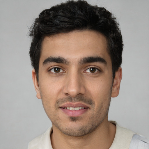 Joyful white young-adult male with short  black hair and brown eyes