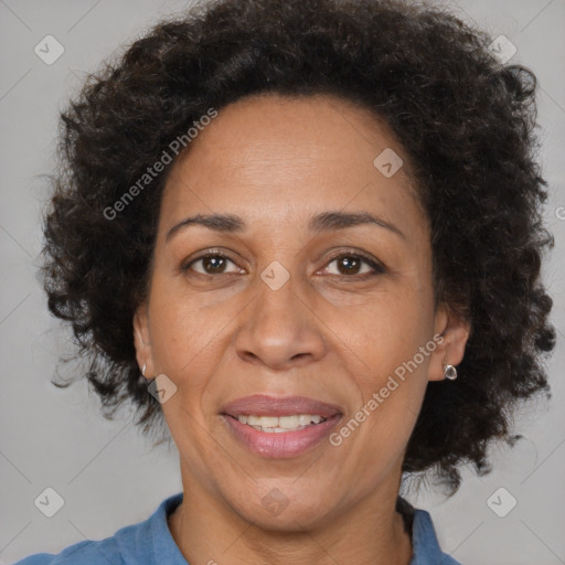 Joyful black adult female with medium  brown hair and brown eyes