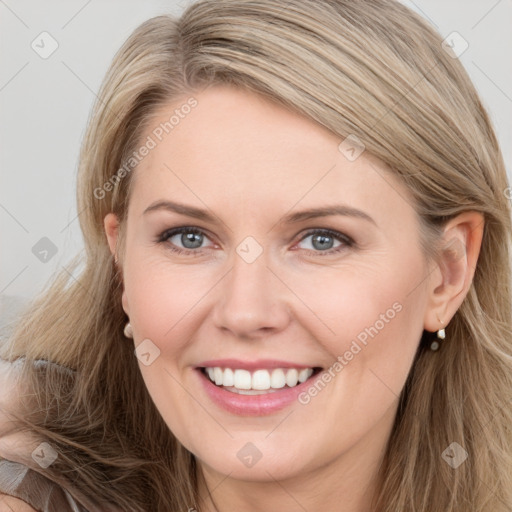 Joyful white young-adult female with long  brown hair and grey eyes