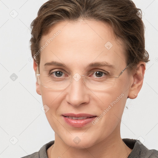 Joyful white adult female with short  brown hair and grey eyes