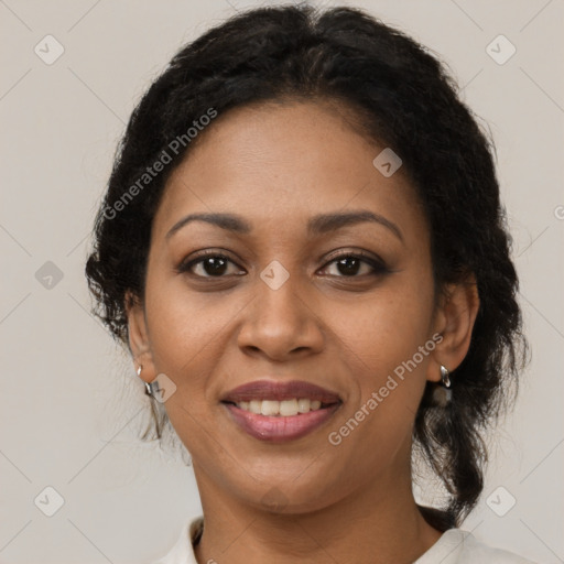 Joyful black adult female with medium  brown hair and brown eyes