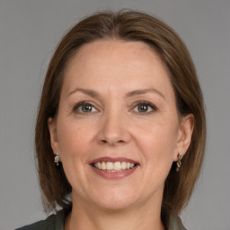 Joyful white adult female with medium  brown hair and grey eyes