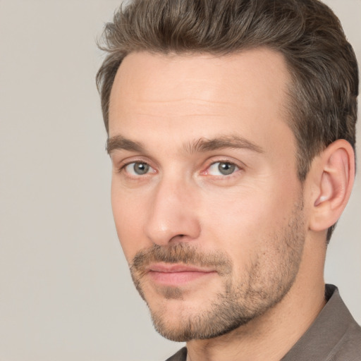 Joyful white adult male with short  brown hair and brown eyes