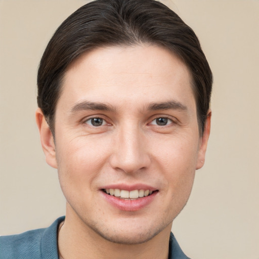 Joyful white young-adult male with short  brown hair and brown eyes