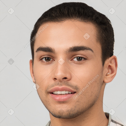 Joyful white young-adult male with short  black hair and brown eyes