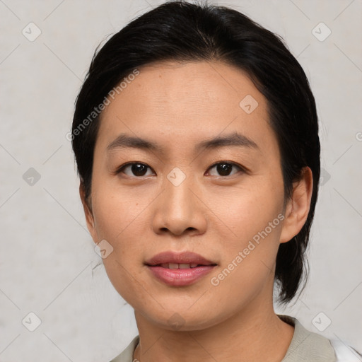 Joyful asian young-adult female with medium  black hair and brown eyes