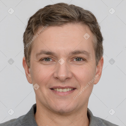 Joyful white adult male with short  brown hair and grey eyes