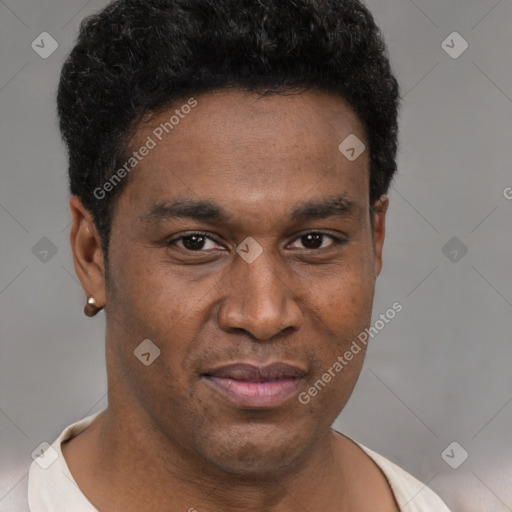 Joyful black young-adult male with short  brown hair and brown eyes