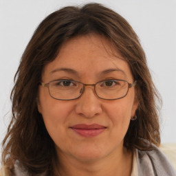 Joyful white adult female with long  brown hair and brown eyes