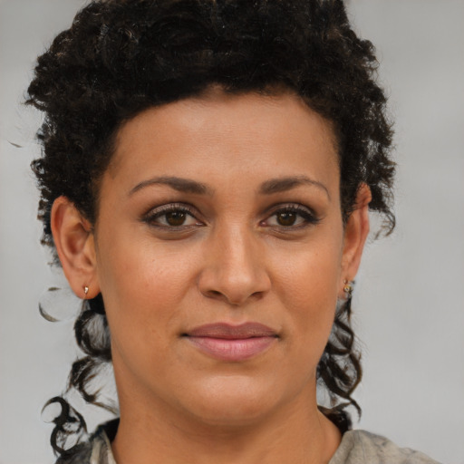 Joyful latino young-adult female with short  brown hair and brown eyes