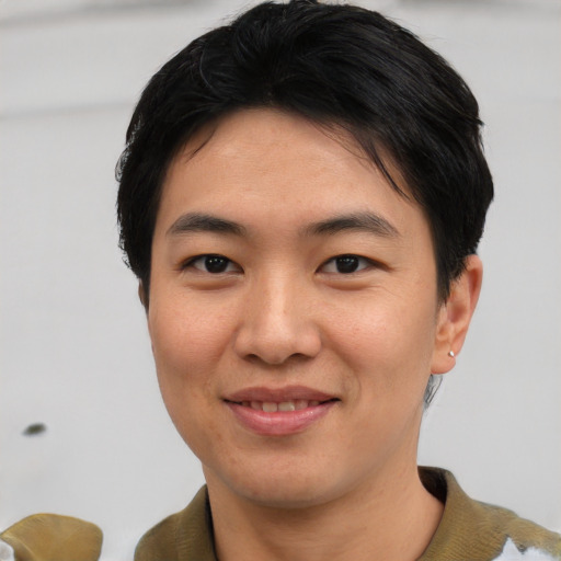 Joyful asian young-adult male with short  black hair and brown eyes