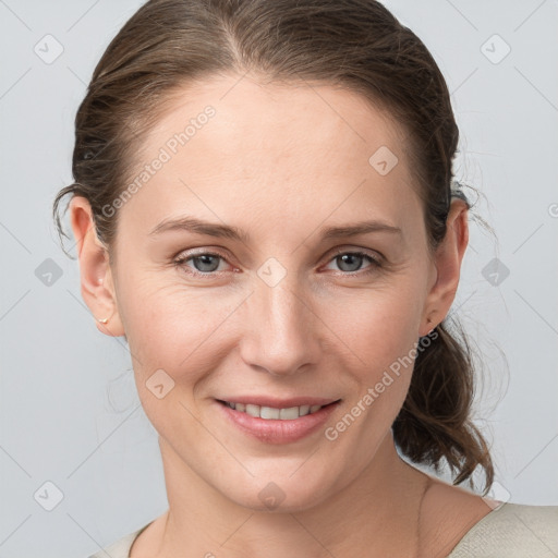 Joyful white young-adult female with medium  brown hair and grey eyes