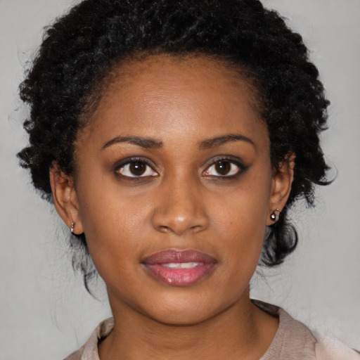 Joyful black young-adult female with medium  brown hair and brown eyes
