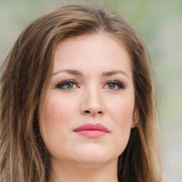 Joyful white young-adult female with long  brown hair and green eyes