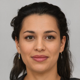 Joyful latino young-adult female with medium  brown hair and brown eyes