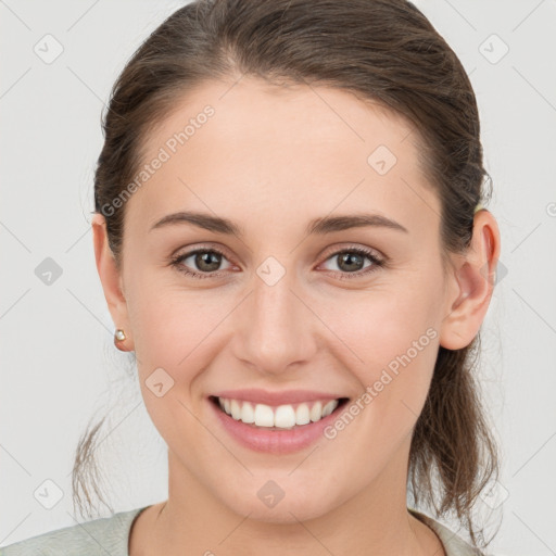 Joyful white young-adult female with medium  brown hair and grey eyes