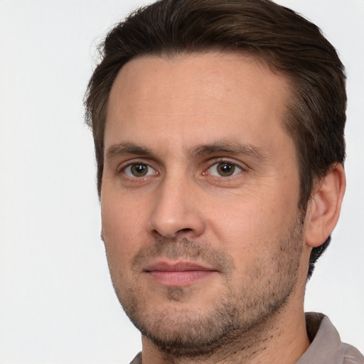 Joyful white adult male with short  brown hair and brown eyes