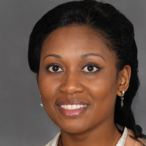 Joyful black young-adult female with medium  black hair and brown eyes