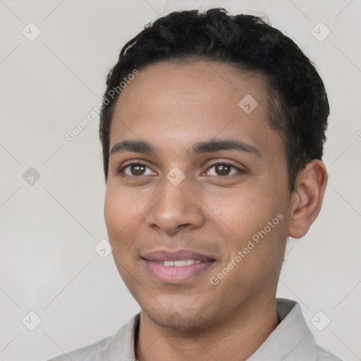 Joyful latino young-adult male with short  black hair and brown eyes