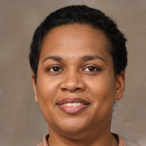 Joyful latino adult female with short  black hair and brown eyes