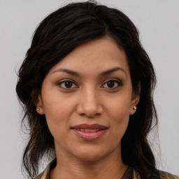 Joyful latino young-adult female with medium  brown hair and brown eyes