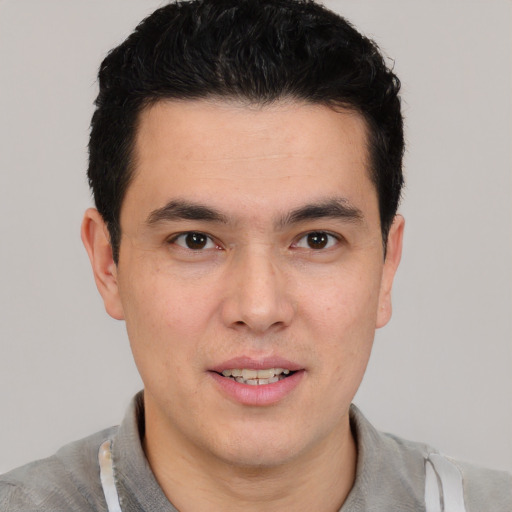 Joyful white young-adult male with short  black hair and brown eyes