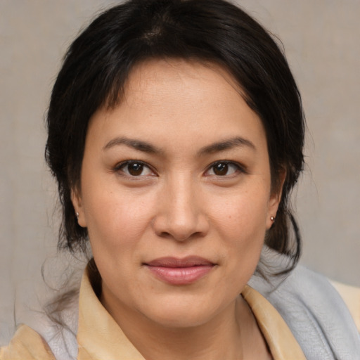 Joyful latino young-adult female with medium  brown hair and brown eyes