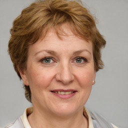 Joyful white adult female with medium  brown hair and blue eyes