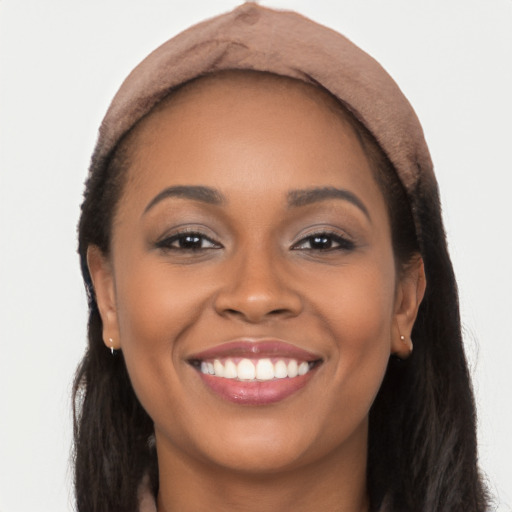 Joyful latino young-adult female with long  brown hair and brown eyes