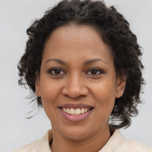 Joyful latino adult female with long  brown hair and brown eyes