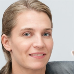 Joyful white young-adult female with long  brown hair and blue eyes