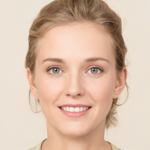 Joyful white young-adult female with medium  brown hair and blue eyes