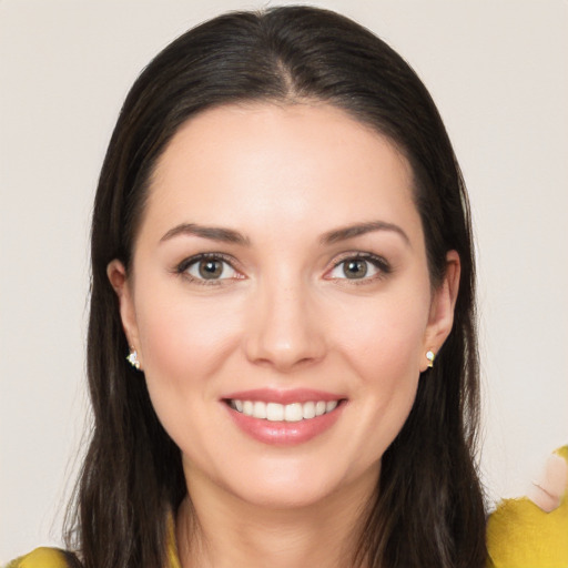 Joyful white young-adult female with long  brown hair and brown eyes