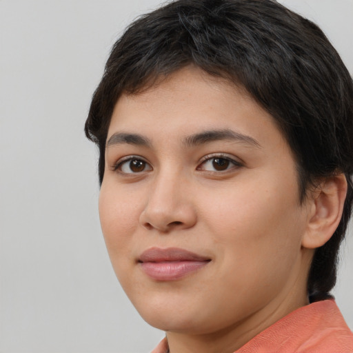 Joyful latino young-adult female with short  brown hair and brown eyes