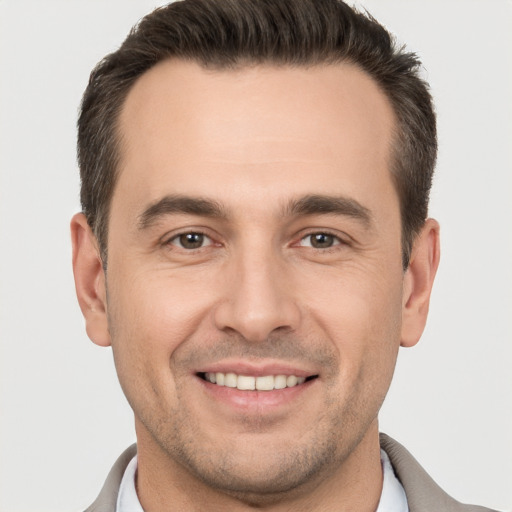 Joyful white young-adult male with short  brown hair and brown eyes