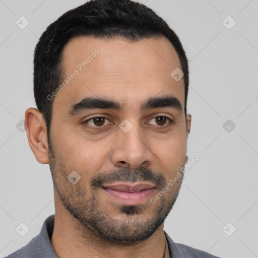 Joyful latino young-adult male with short  black hair and brown eyes