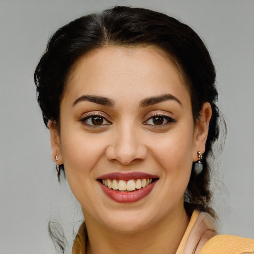 Joyful latino young-adult female with medium  brown hair and brown eyes