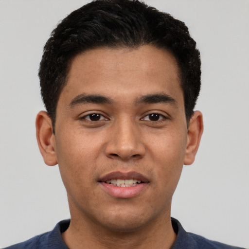 Joyful white young-adult male with short  black hair and brown eyes