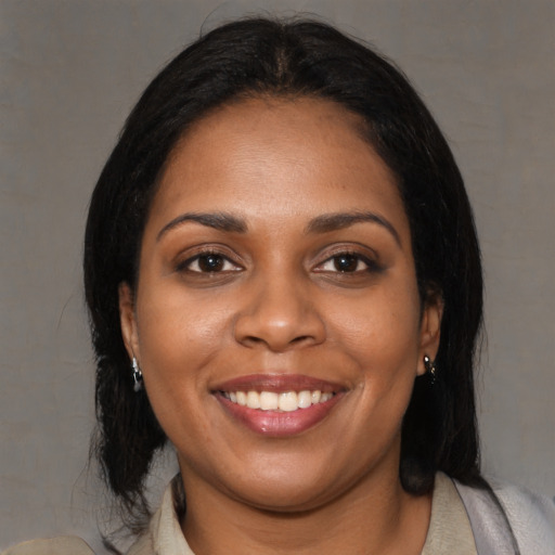 Joyful black young-adult female with medium  black hair and brown eyes