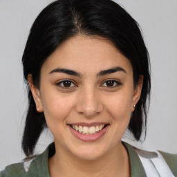 Joyful latino young-adult female with medium  brown hair and brown eyes