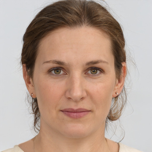 Joyful white adult female with medium  brown hair and grey eyes