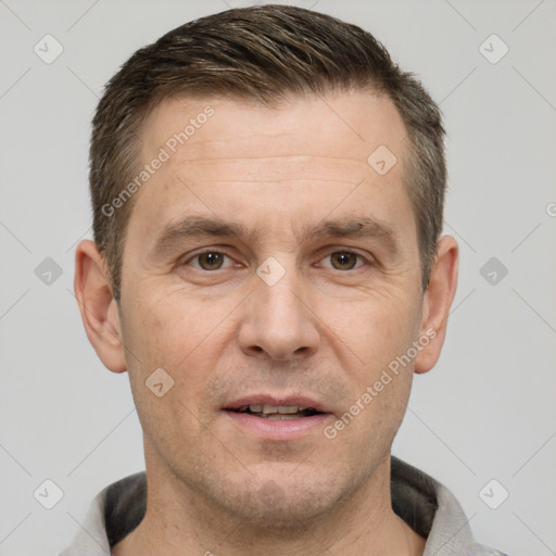 Joyful white adult male with short  brown hair and brown eyes