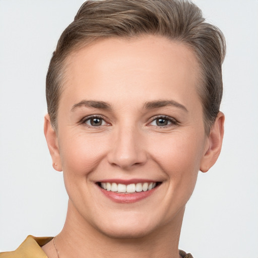 Joyful white young-adult female with short  brown hair and brown eyes